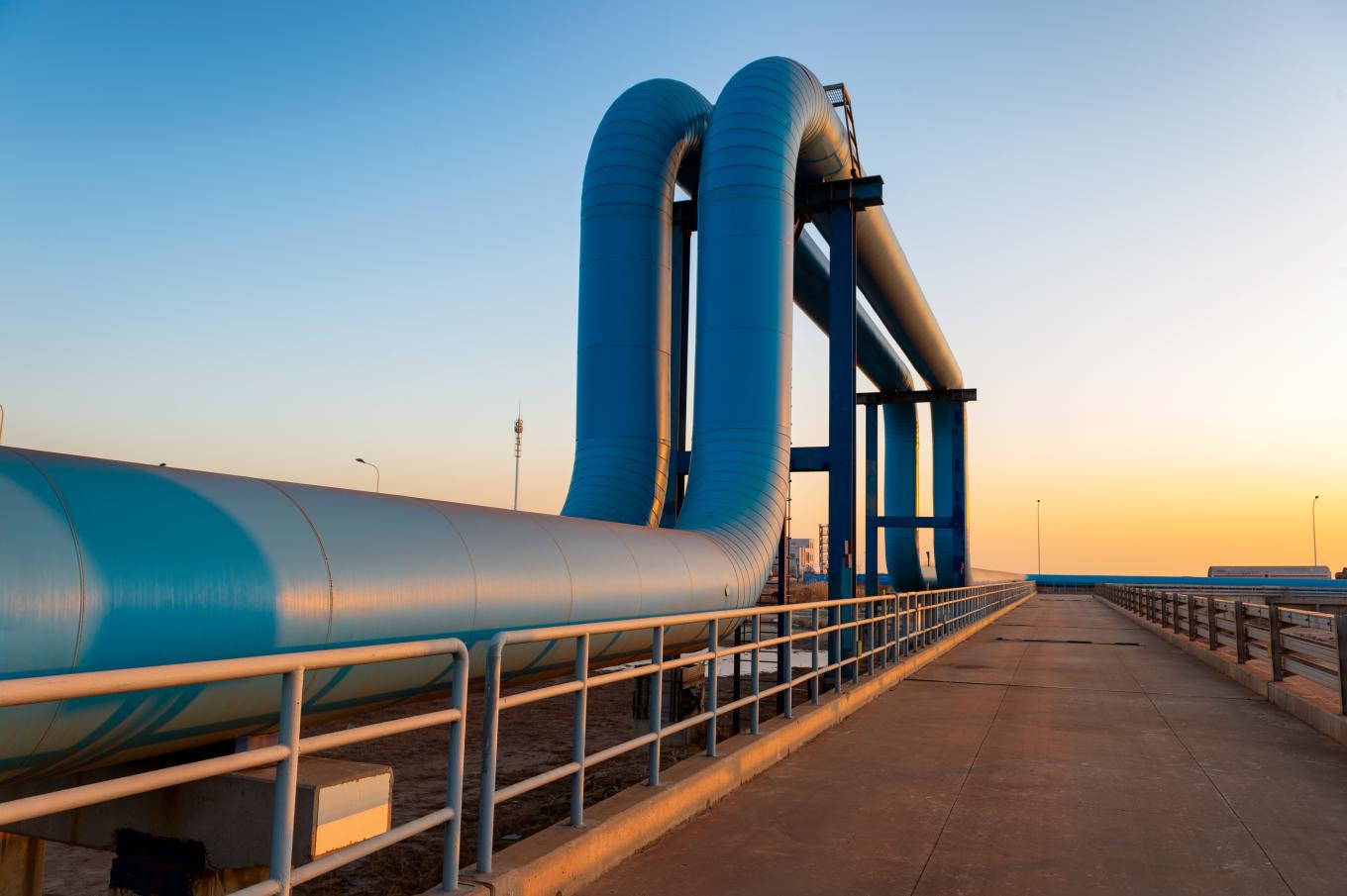 Blue pipes going to oil refinery - stock photo