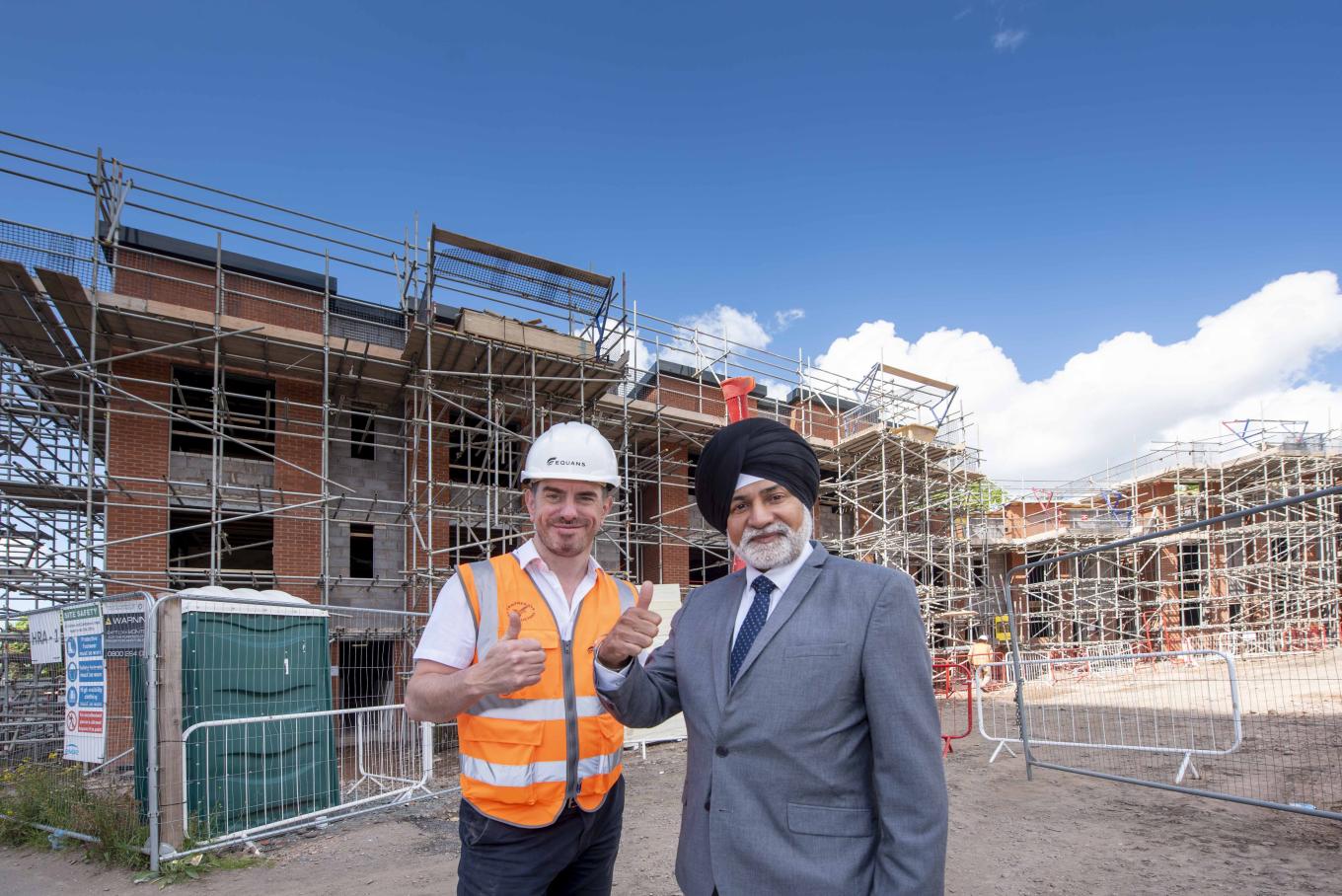 Simon Hoult, EQUANS Project Manager, and Councillor Bhupinder Gakhal, City of Wolverhampton Council Cabinet Member for City Assets and Housing, in front of the new council homes at Heath Town
