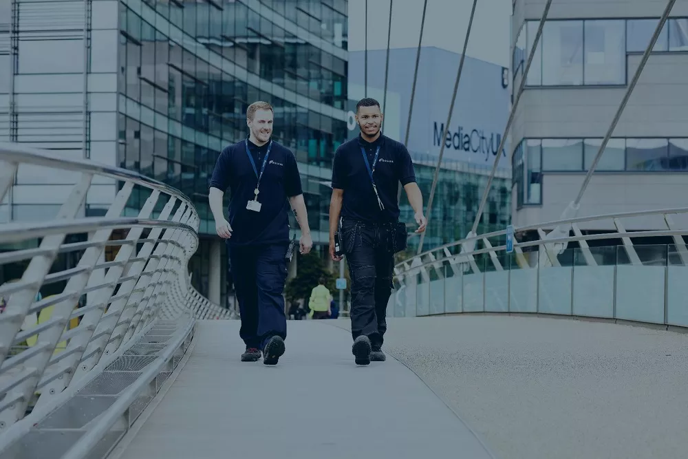 Two Equans employees walking
