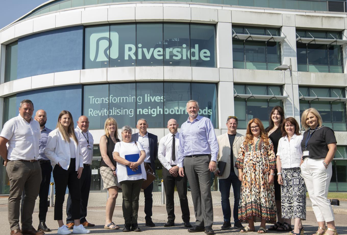 Equans and Riverside staff standing outside Riverside HQ