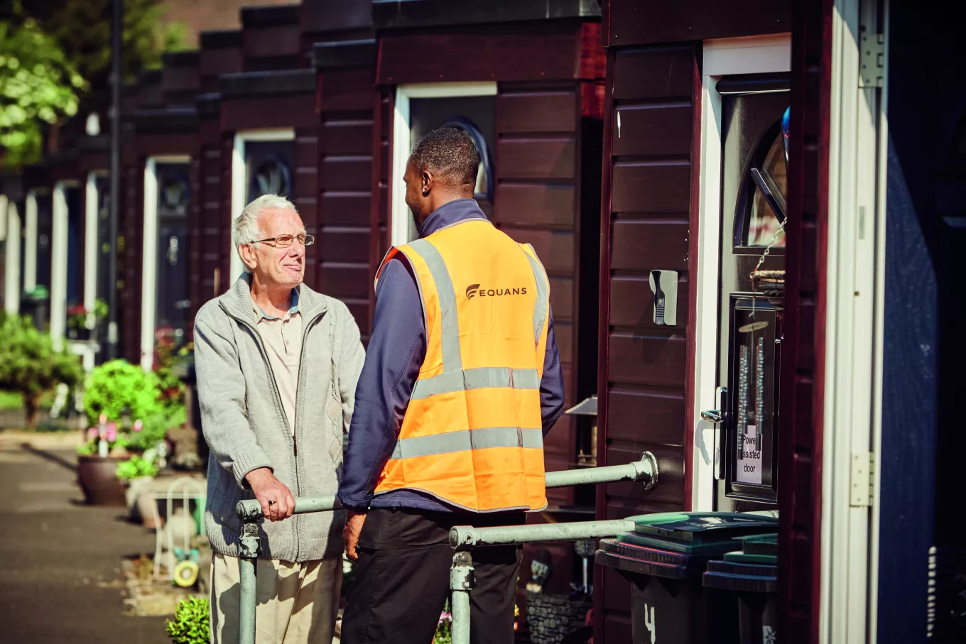 Equans employee with older social housing resident outside their home