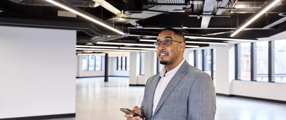 Equans Smart Buildings employee inspecting office lights