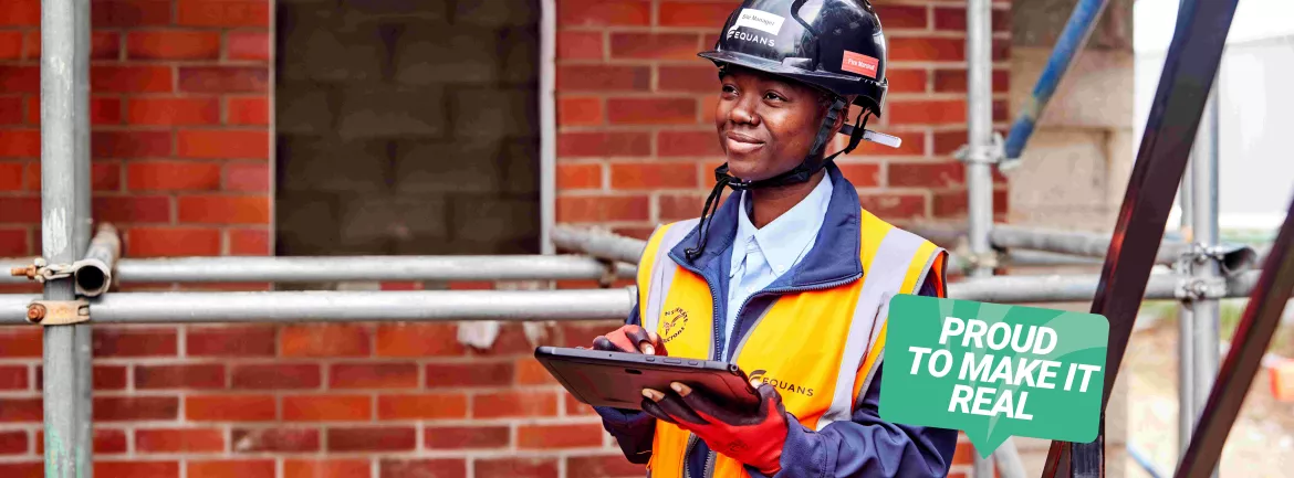 Image of Equans employee holding a clipboard at a site