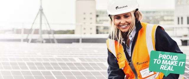 Equans employee standing next to roof top solar in Newcastle