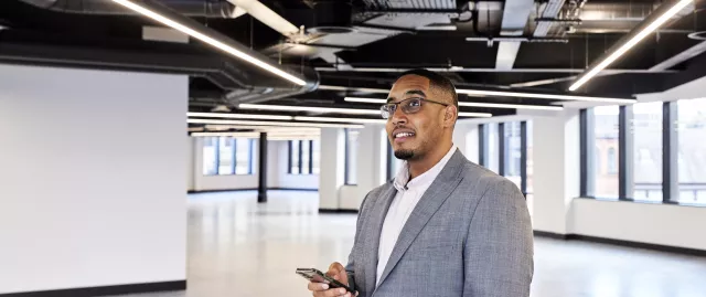 Equans Smart Buildings employee inspecting office lights