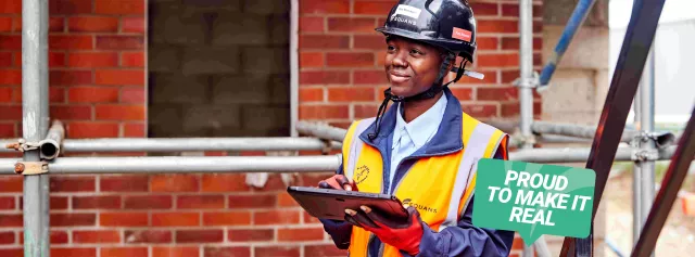 Image of Equans employee holding a clipboard at a site