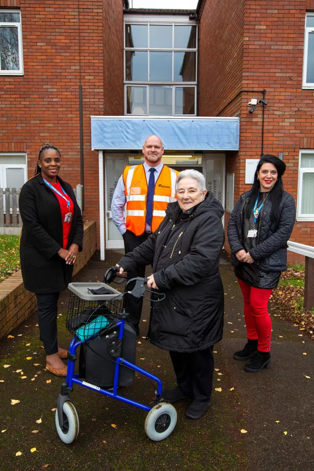Key stakeholders including a resident outside Woodhouse Court in Dudley
