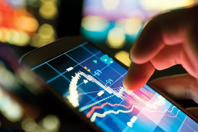 A persons finger touching a digital screen with data on it