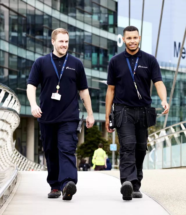 Two Equans FM employees walking