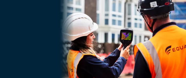 Equans employees undertaking building inspection with thermal camera