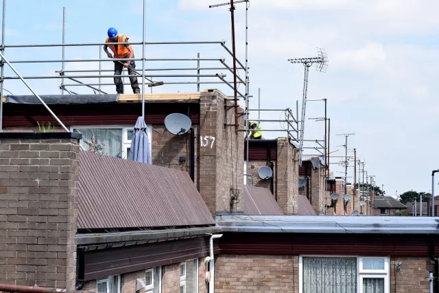 A worker on roof of housing estate