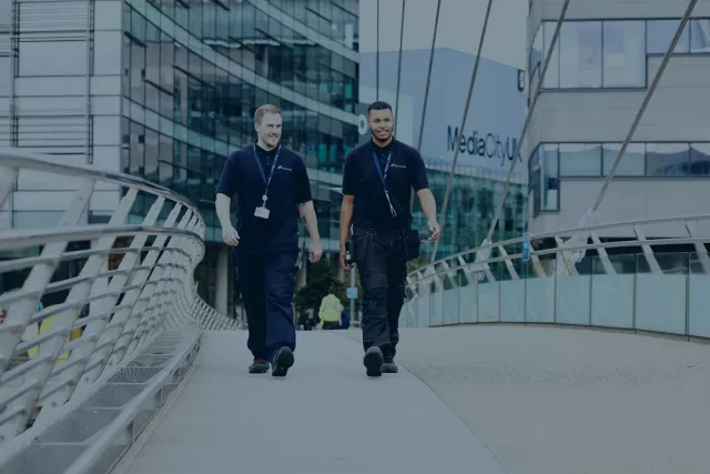 Two Equans employees walking